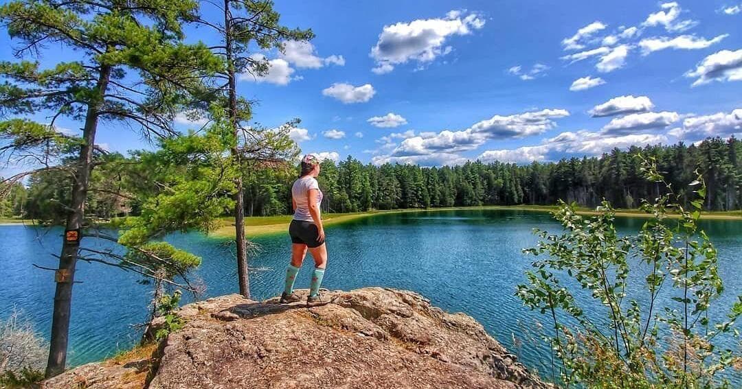 McGinnis Lake at Petroglyphs Provincial Park, its water an unusual turquoise green against the pink granite