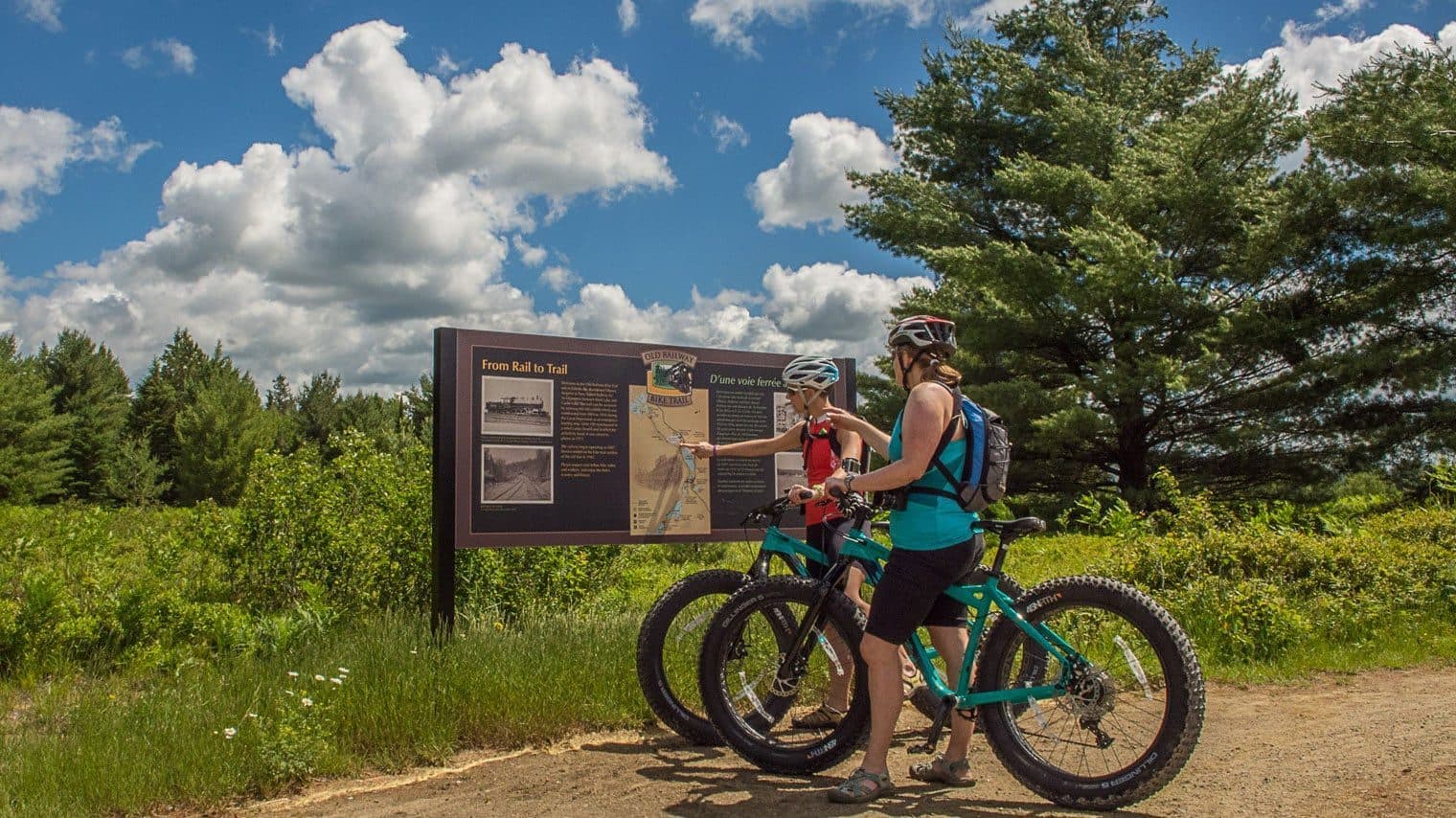 Two cyclists with rented bikes on the Old Railway Bike Trail in Algonquin