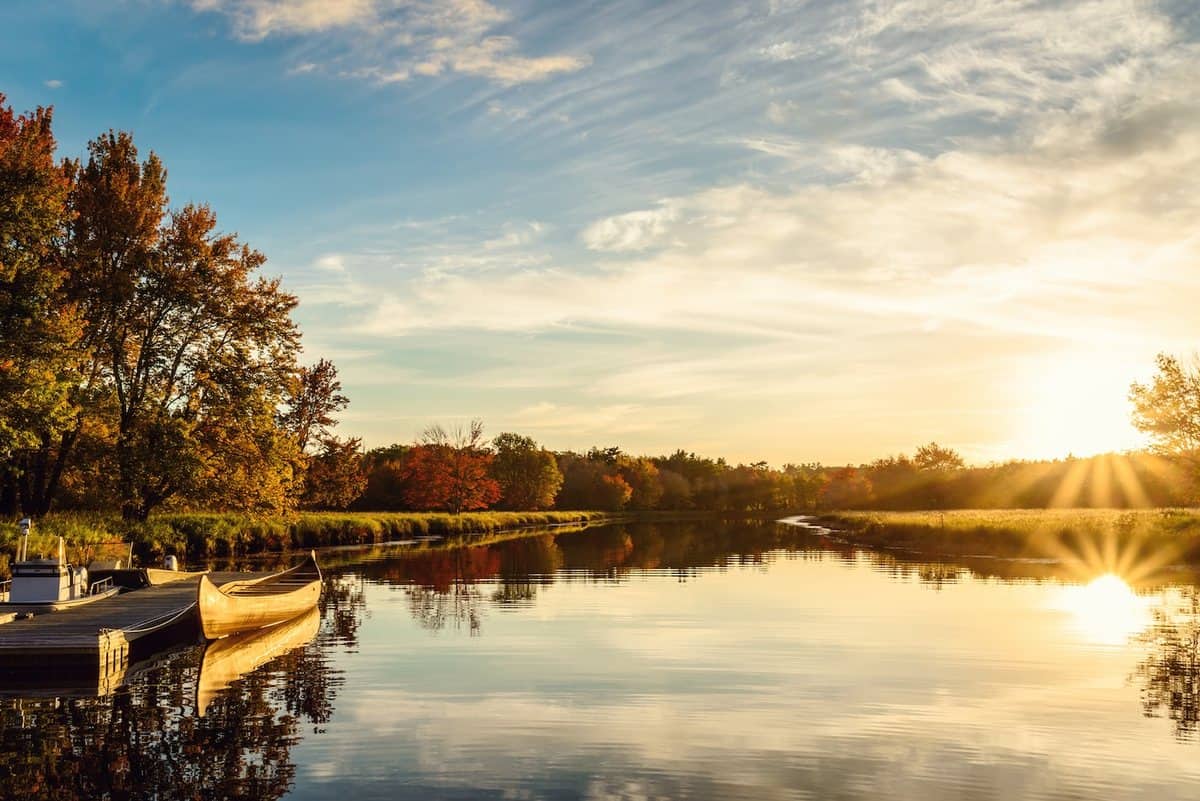 Canoes pulled up on the shore of a lake at Kejimkujik National Park at sunset