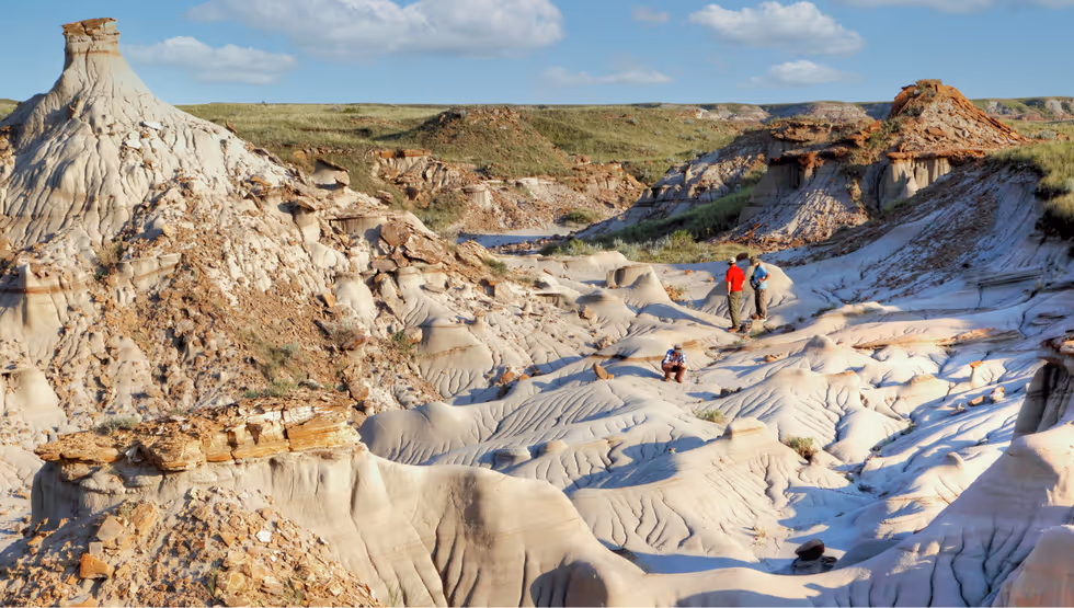 Hoodoos and eroded badlands at Dinosaur Provincial Park with a walker for scale