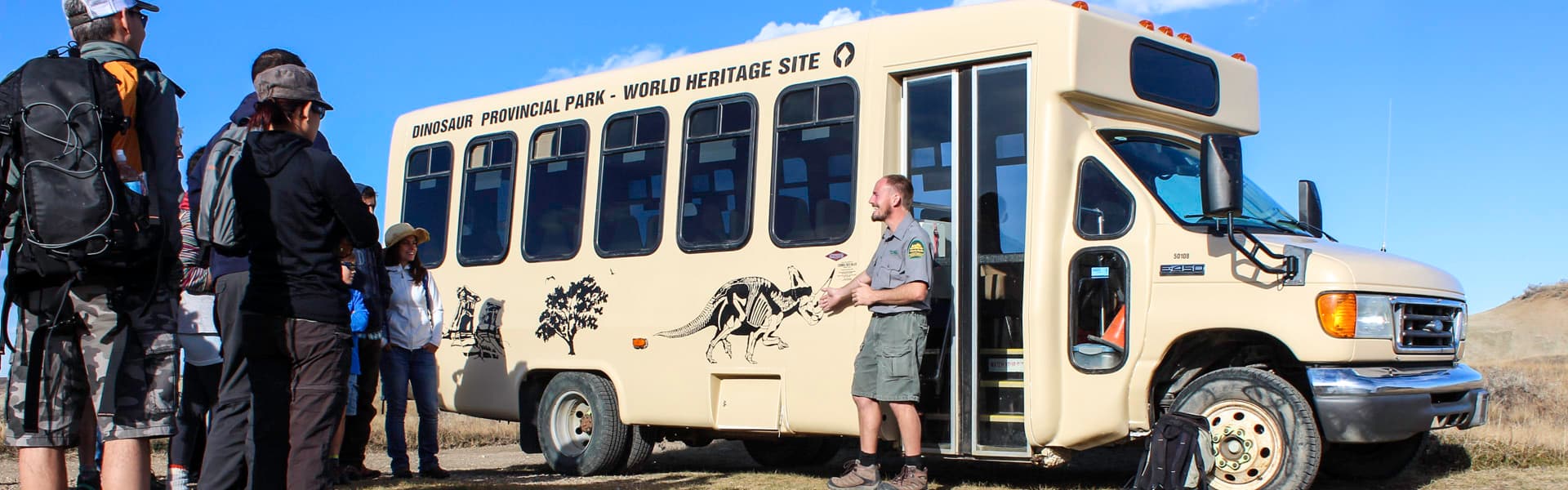 Visitors boarding the park's Explorers Bus at Dinosaur Provincial Park