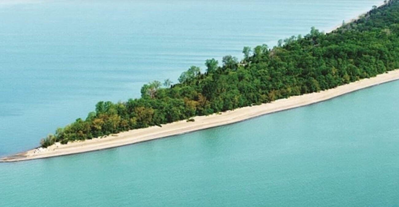 The sand spit at the Tip of Point Pelee narrowing into the turquoise water of Lake Erie