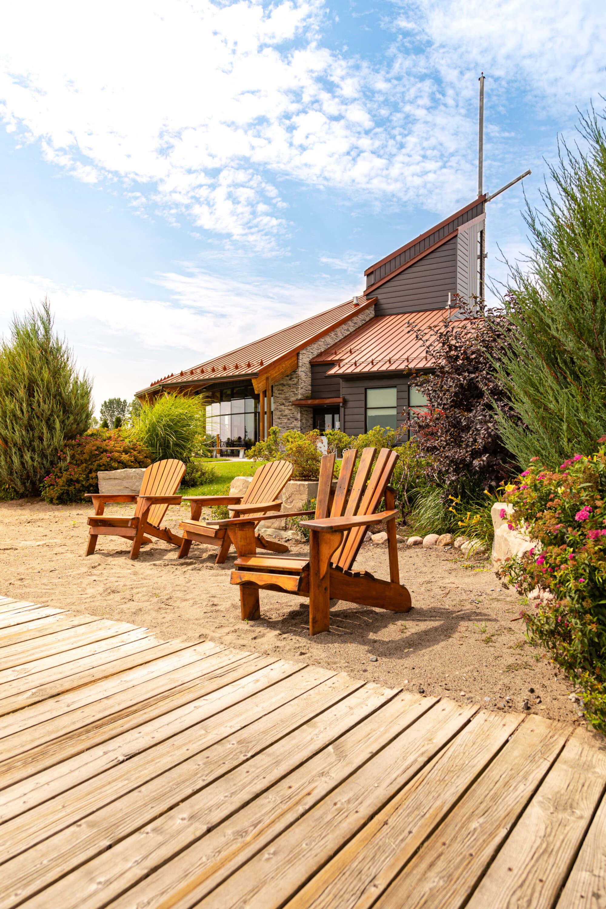 Wooden chairs on a boardwalk deck at Brambleberry Farm