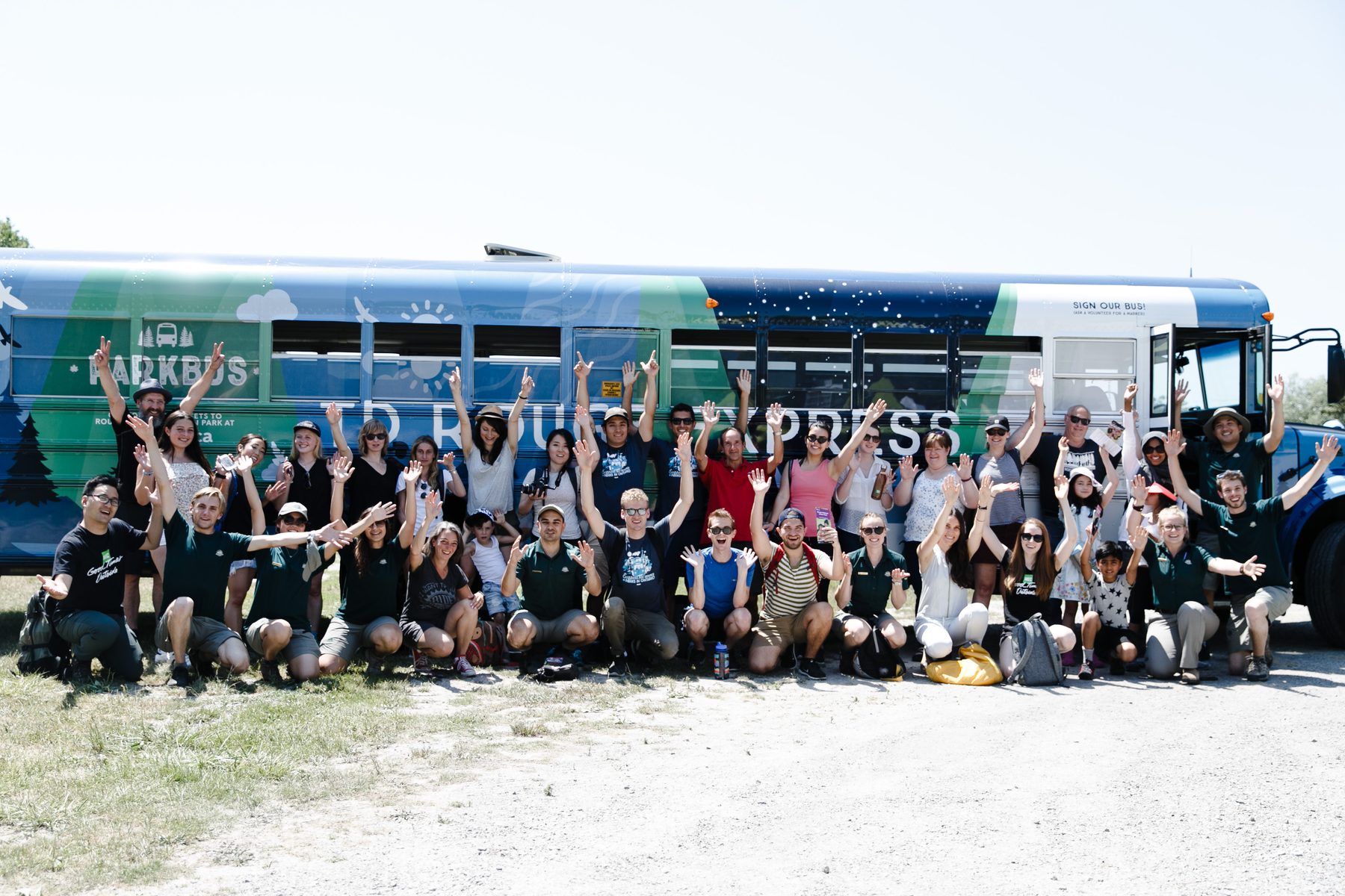 Parkbus staff, volunteers and passengers together in front of the TD Rouge Express bus
