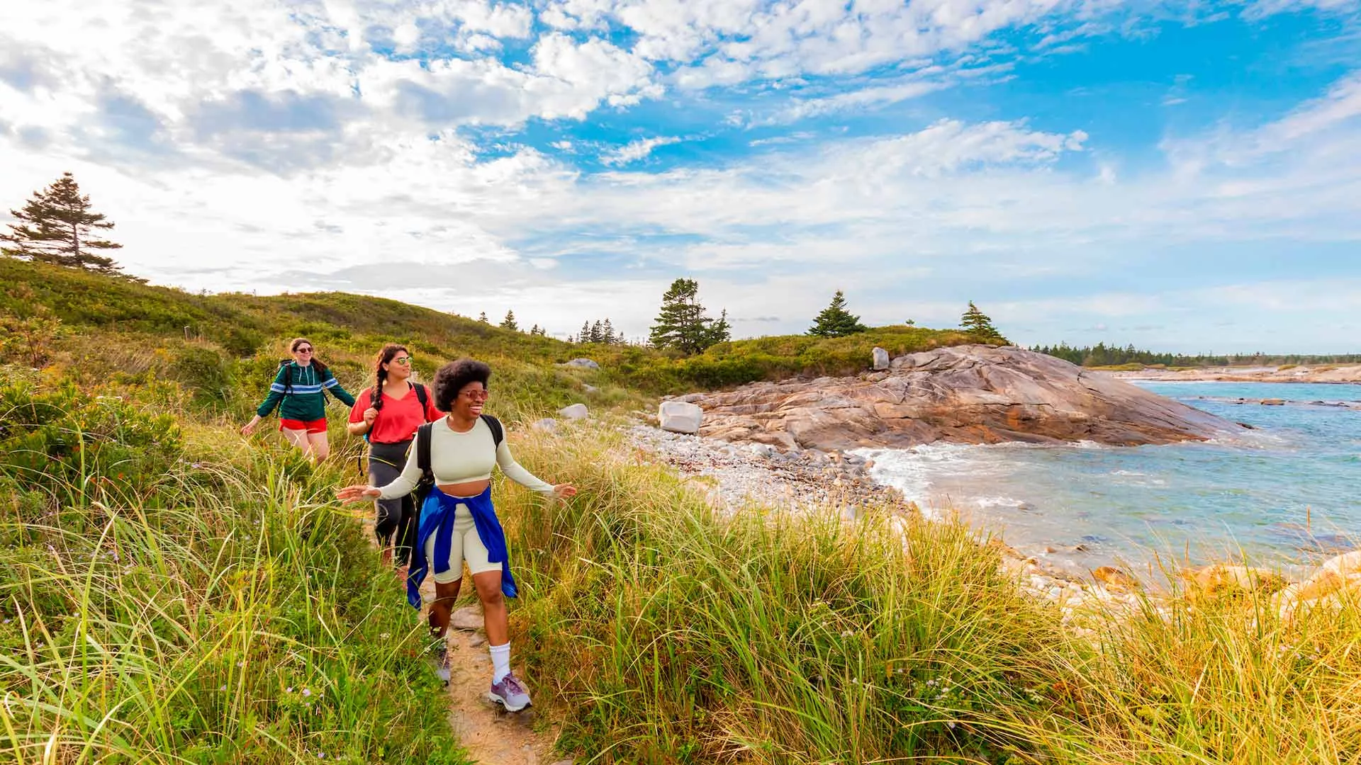 Hikers on the coastal trail at Kejimkujik Seaside, Nova Scotia