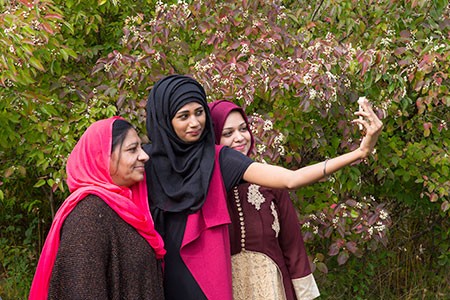 A group of women taking a selfie together outdoors on a NatureLink trip