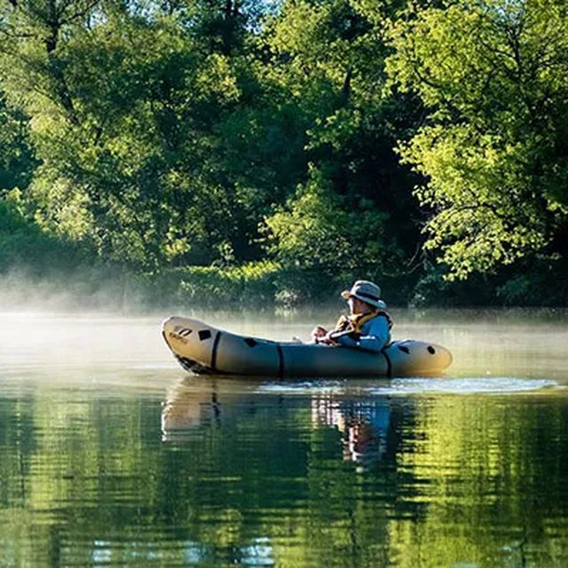 A canoe on a misty river at dawn, from Boris Issaev's own photograph